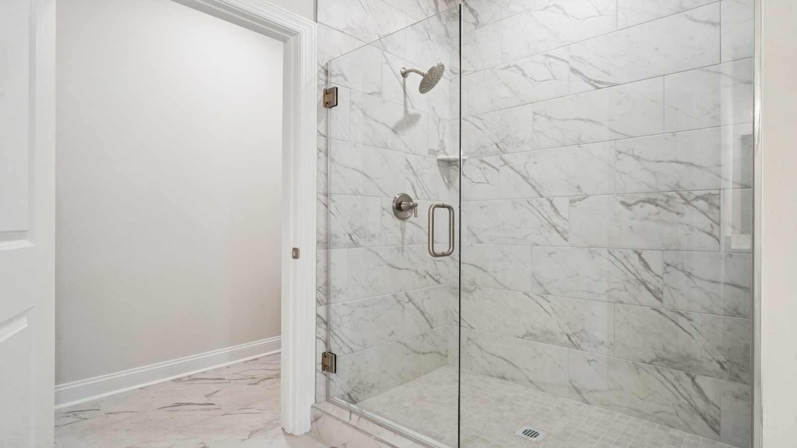 Primary bathroom in this New Build Home includes extended vanity, quality cabinets, walk-in closet and spa-style layout