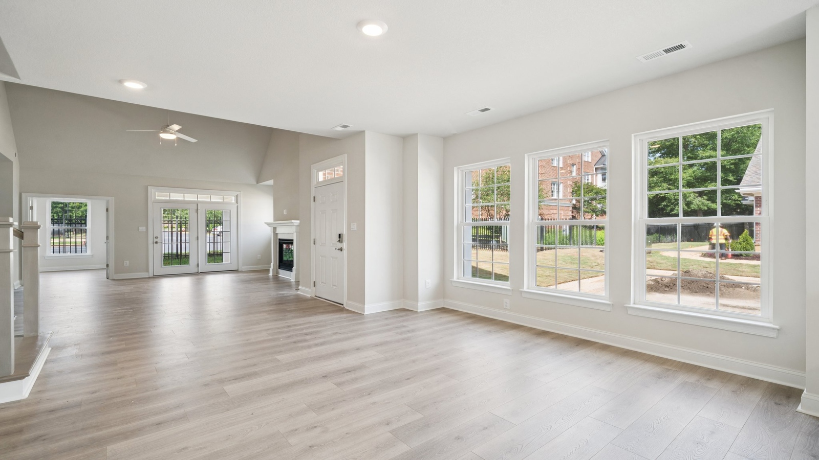 Main living zone with easy access near kitchen, dining area, and an electric fireplace in Country Club Villas