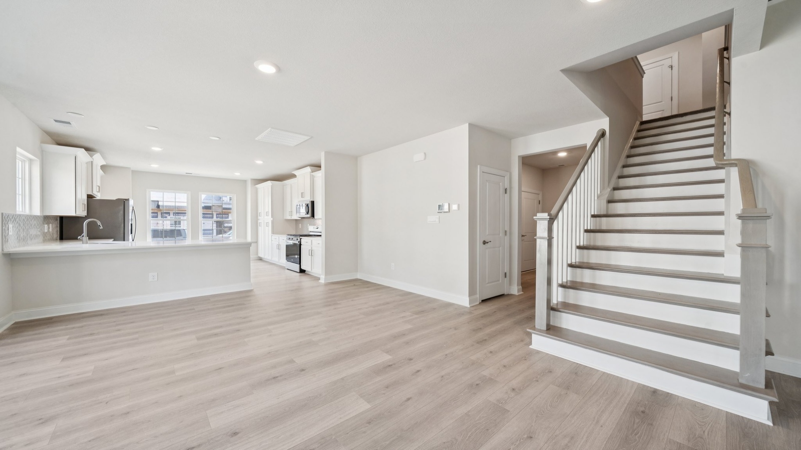 Country Club Villas main floor plan featuring combined kitchen, dining, and living room for everyday lifestyle convenience