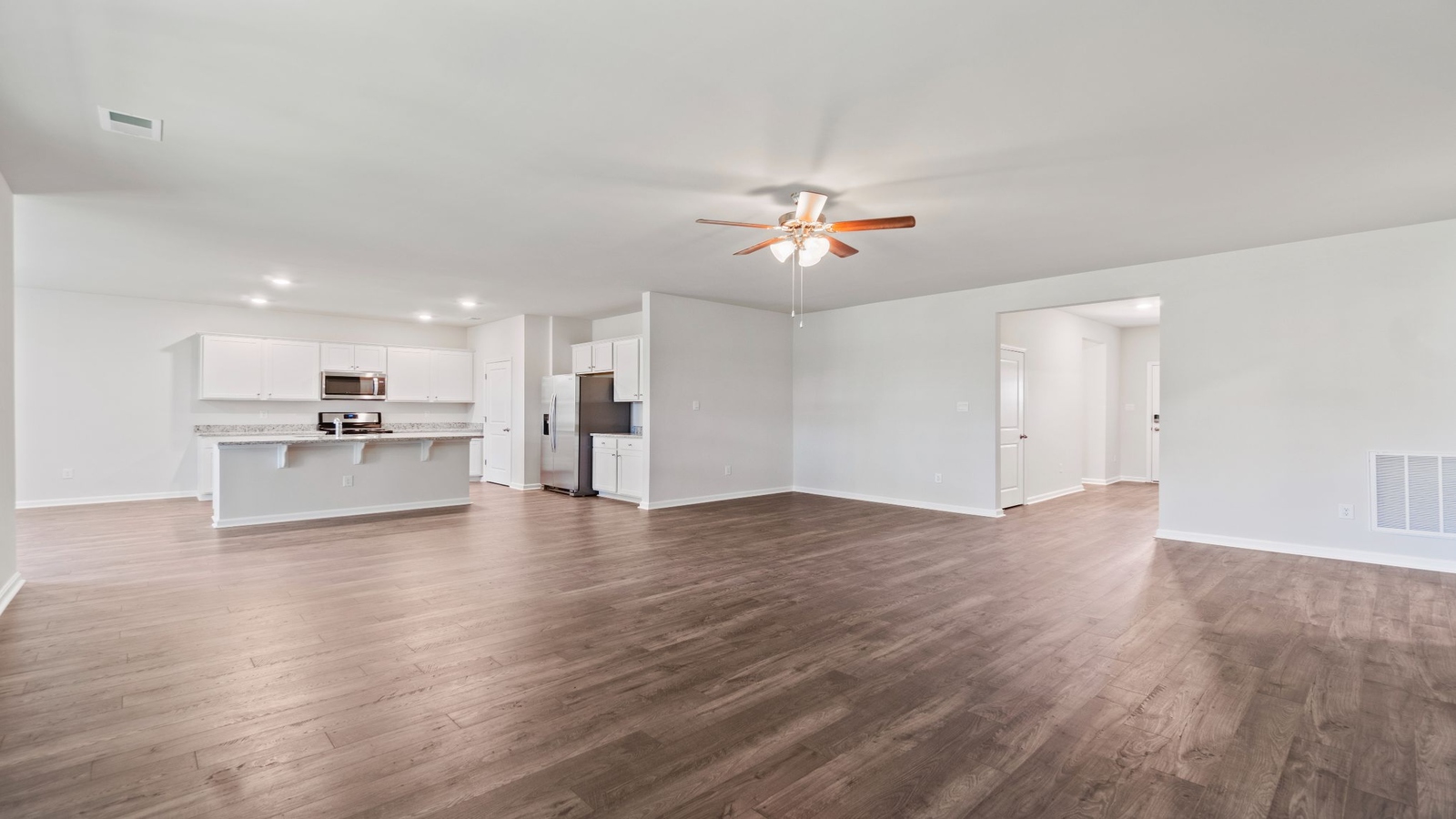 Main living space at Riverview Landing combining kitchen, dining, and living room designed into one comfortable open concept