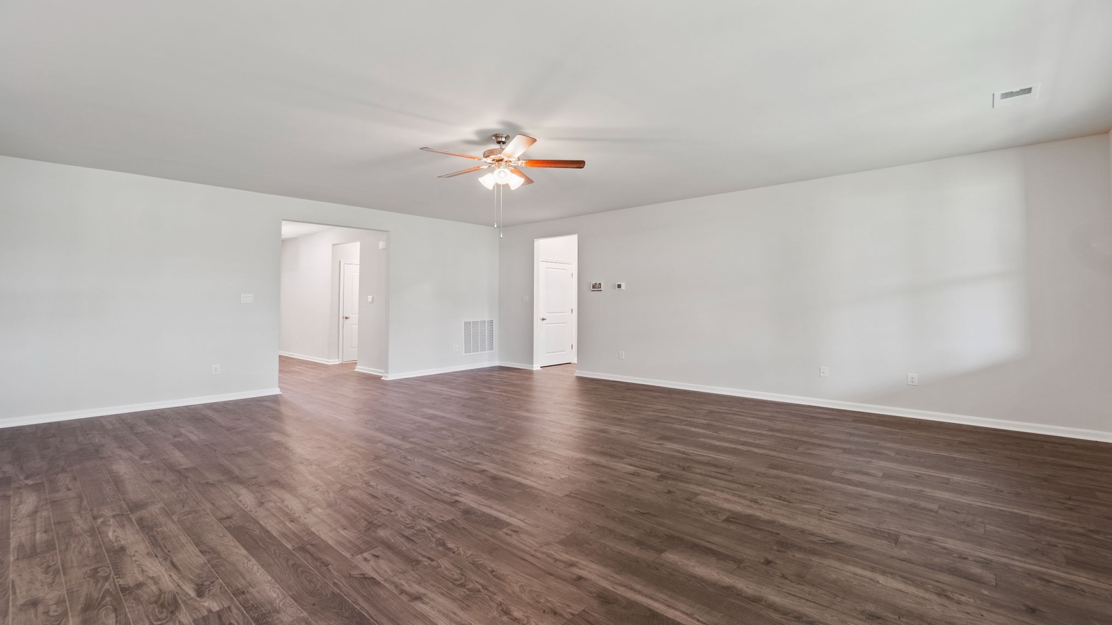Main living space at Riverview Landing offering natural light and open layout between kitchen, dining, and living room