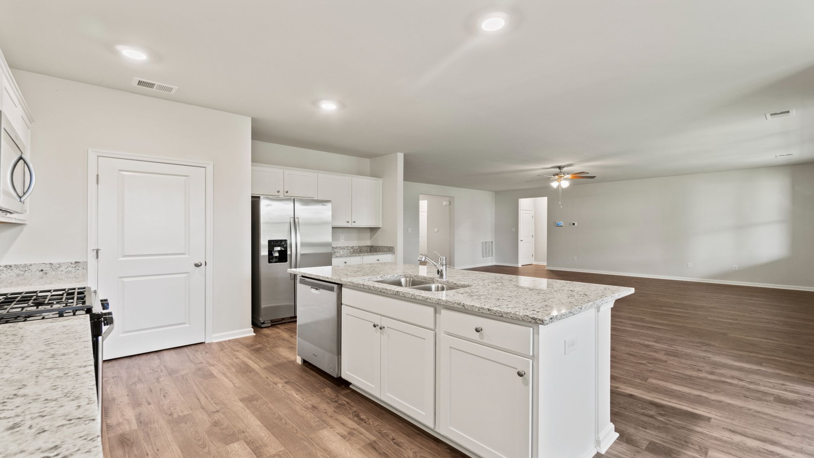 Kitchen island in D.R. Horton layout connects dining and living areas with efficient flow and modern surface finishes