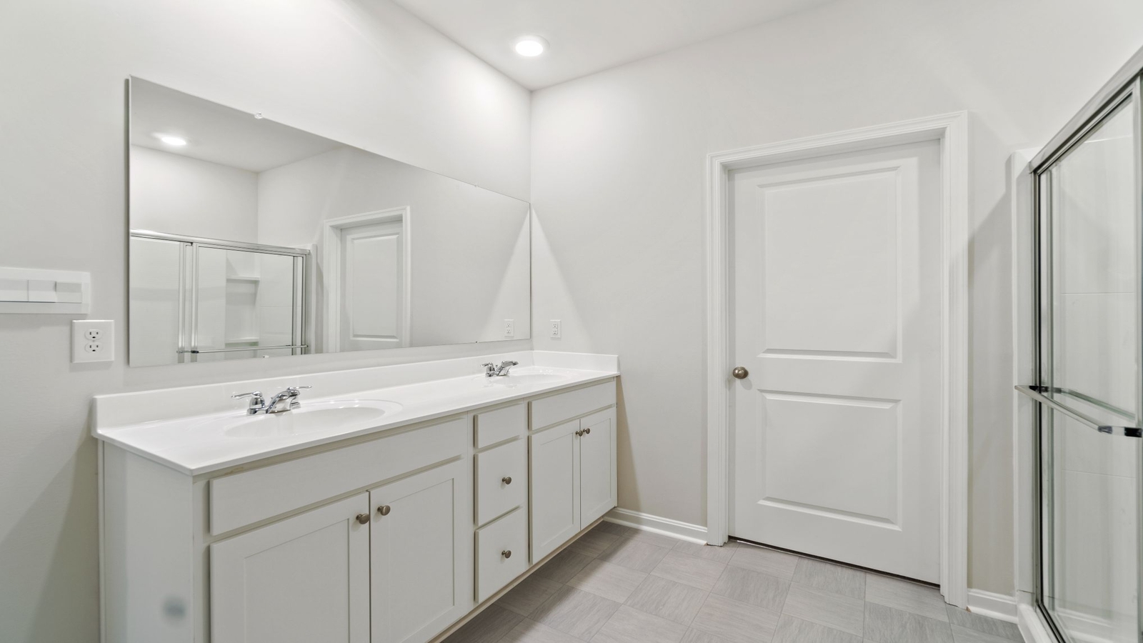 Family shower-bath, modern cabinetry, chrome faucet, storage options at Riverview Landing by D.R. Horton