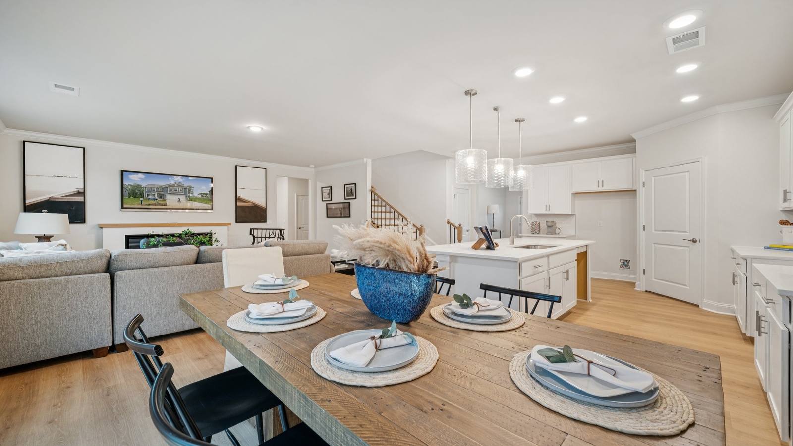 New appliances and a larger island anchor the kitchen, while the adjacent dining-family rooms provide open flexibility.