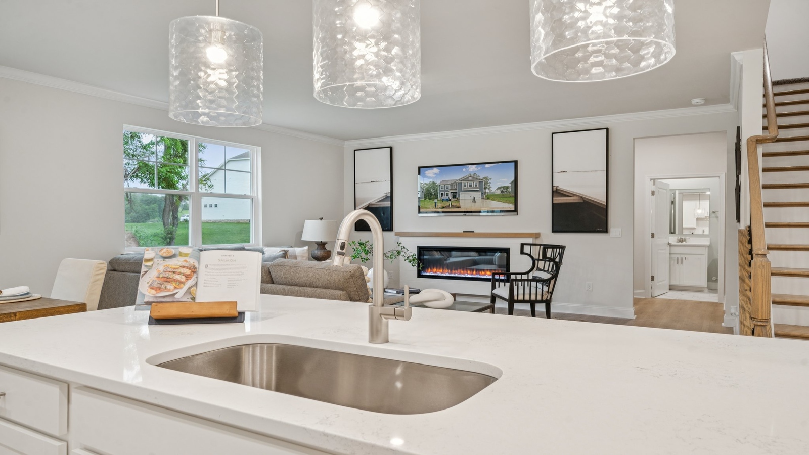 Kitchen island in this D.R. Horton New Home featuring seating, storage, pantry and a New appliance suite