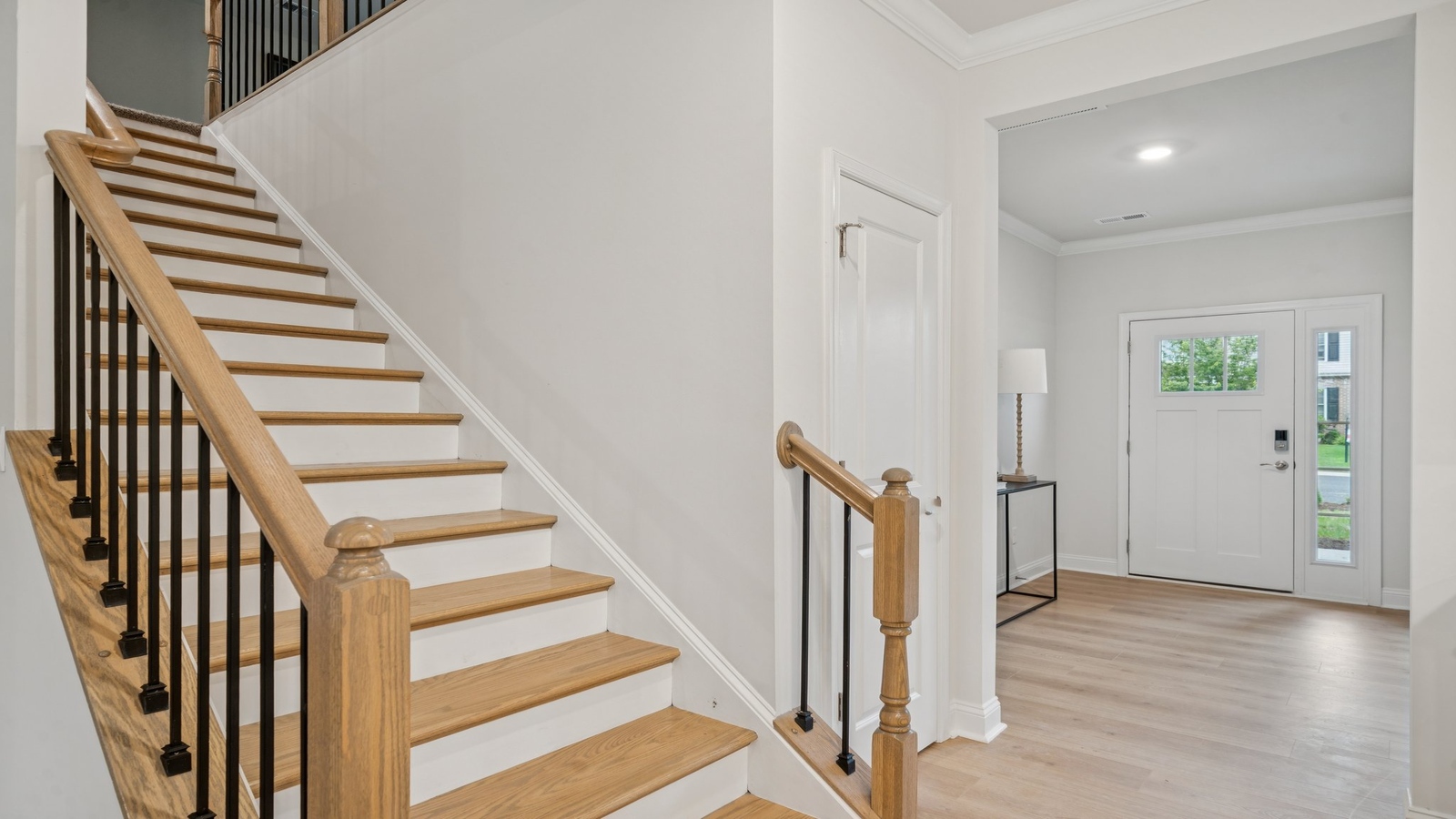 New Home front hallway by D.R. Horton showcases the open design entry, stairs, garage, and central living zones access