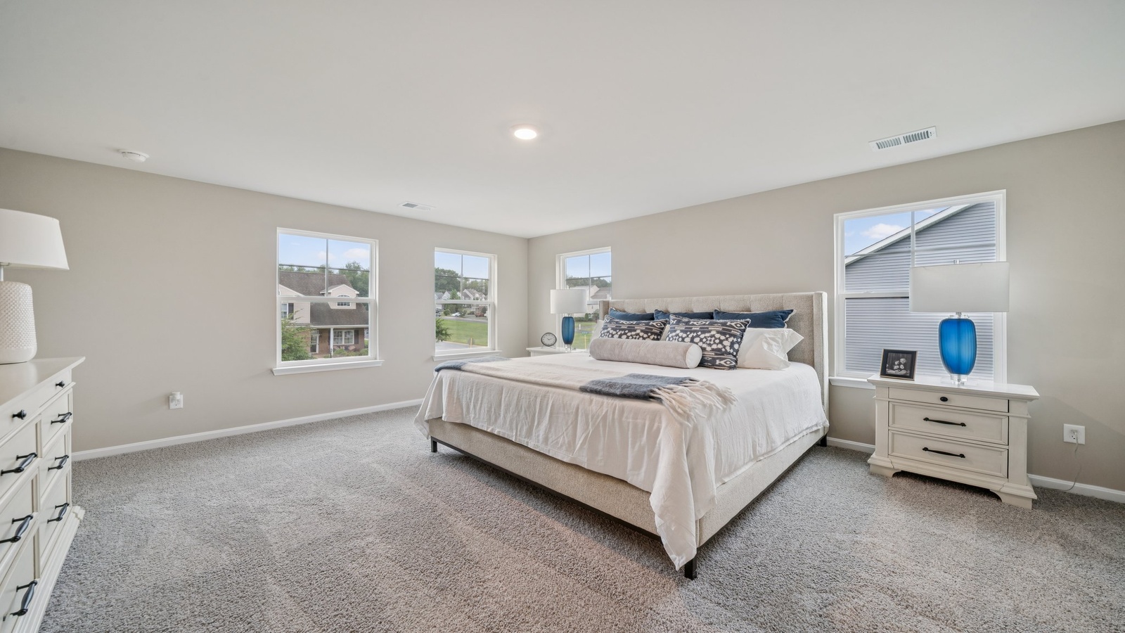 Owner’s suite offers natural window light, a spa-inspired en-suite bathroom, and a walk-in closet for everyday comfort