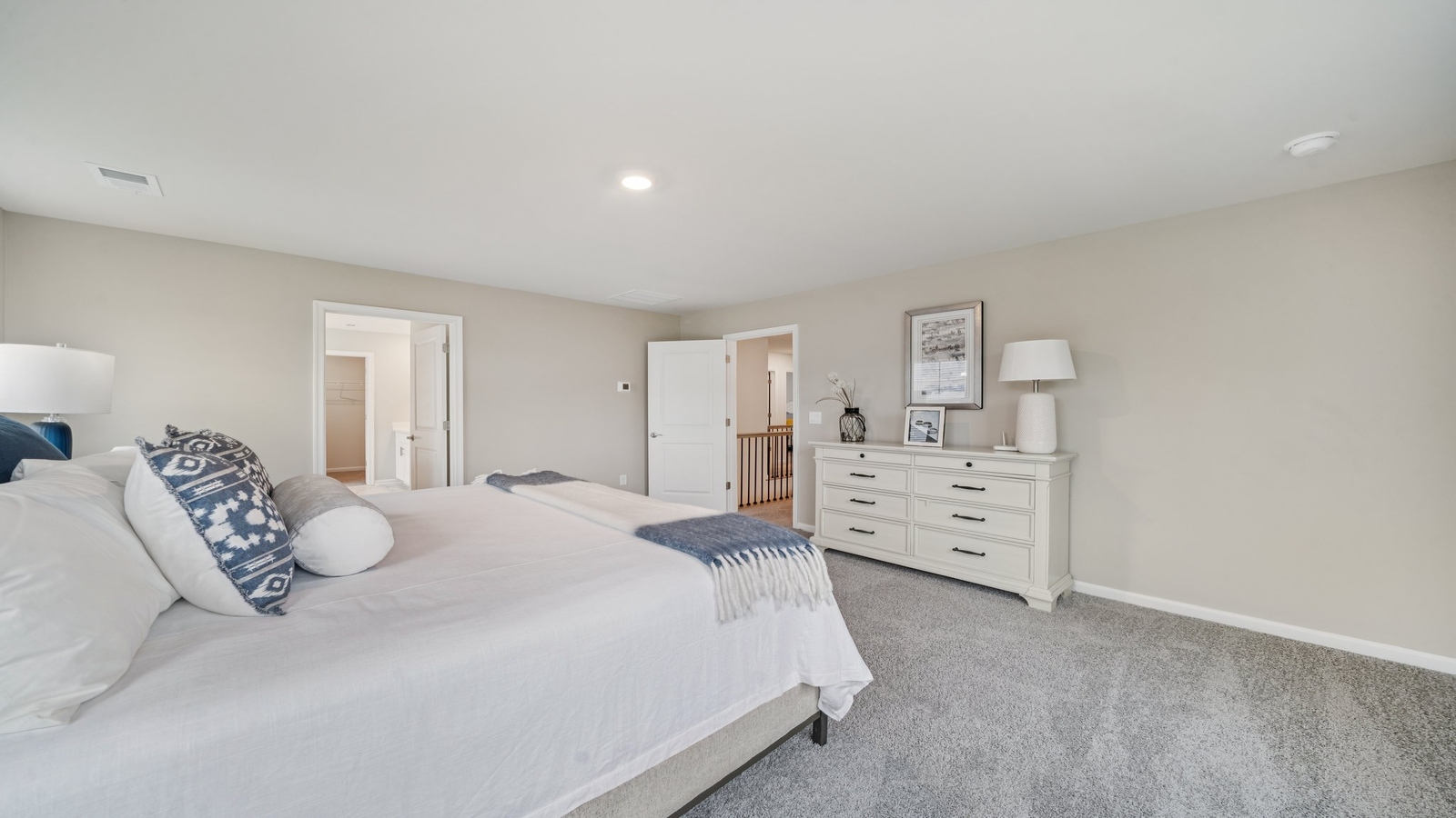 Primary bedroom in this New Home features ample space, double windows, quality carpet, a Walk-in Closet, private En-Suite Bath