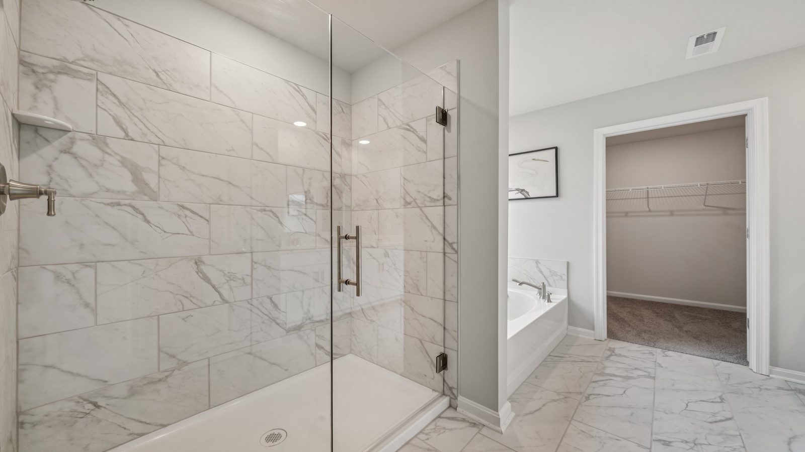 Primary en-suite bathroom in this D.R. Horton New Home featuring dual sinks, expansive vanity, shower-tub, Walk-in Closet