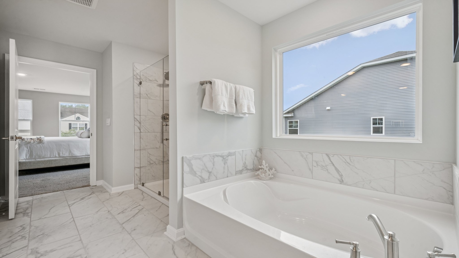 Owner’s en-suite new build home offers a functional layout with a walk-in closet, and spa-like en-suite shower-bath designs