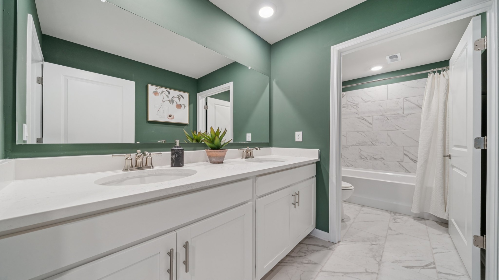 Family bathroom with quality vanity, tub-shower combo, storage in Riverview Landing by D.R. Horton