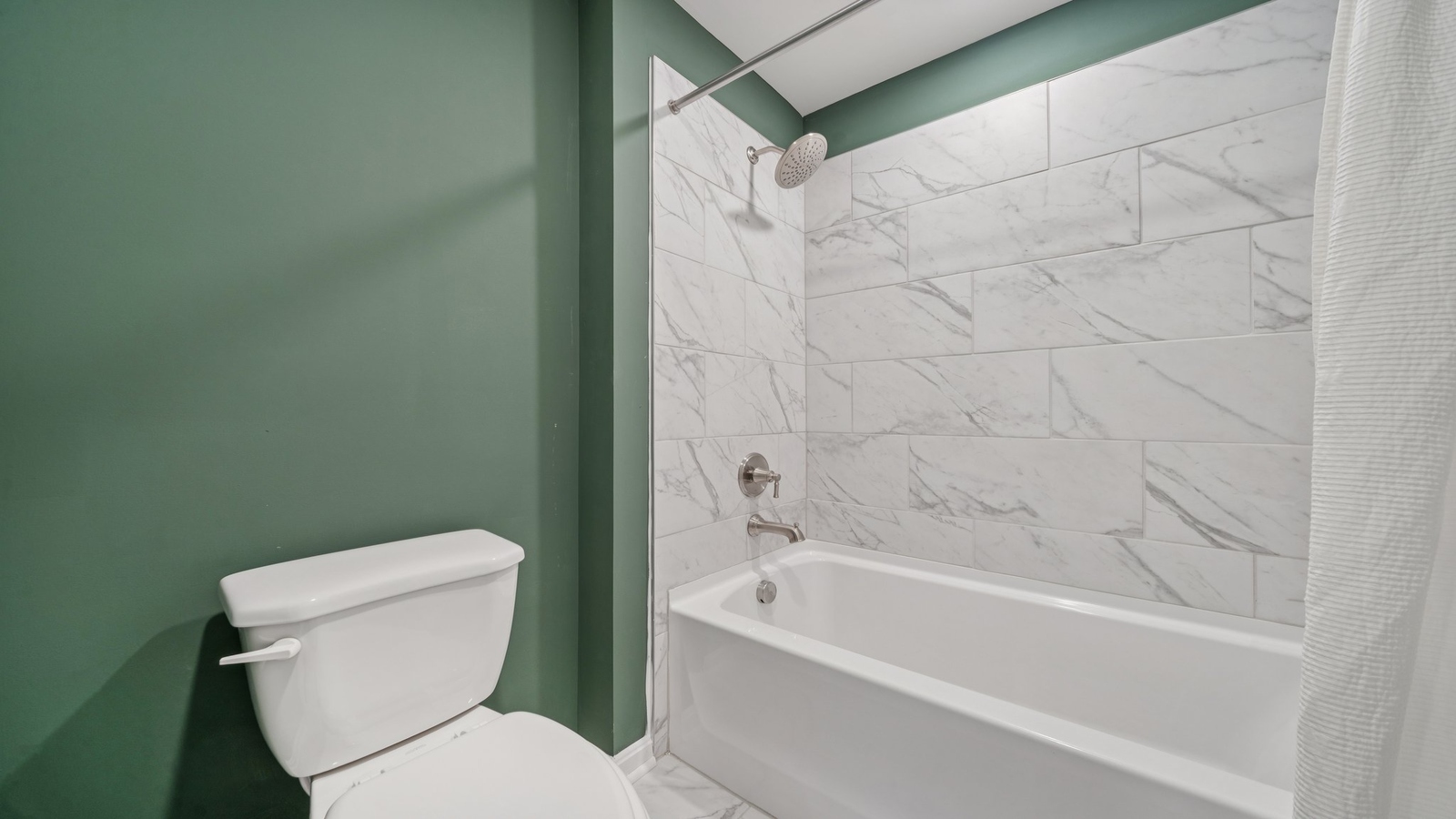 Family bathroom with decorative tile, storage, tub-shower combo in Riverview Landing
