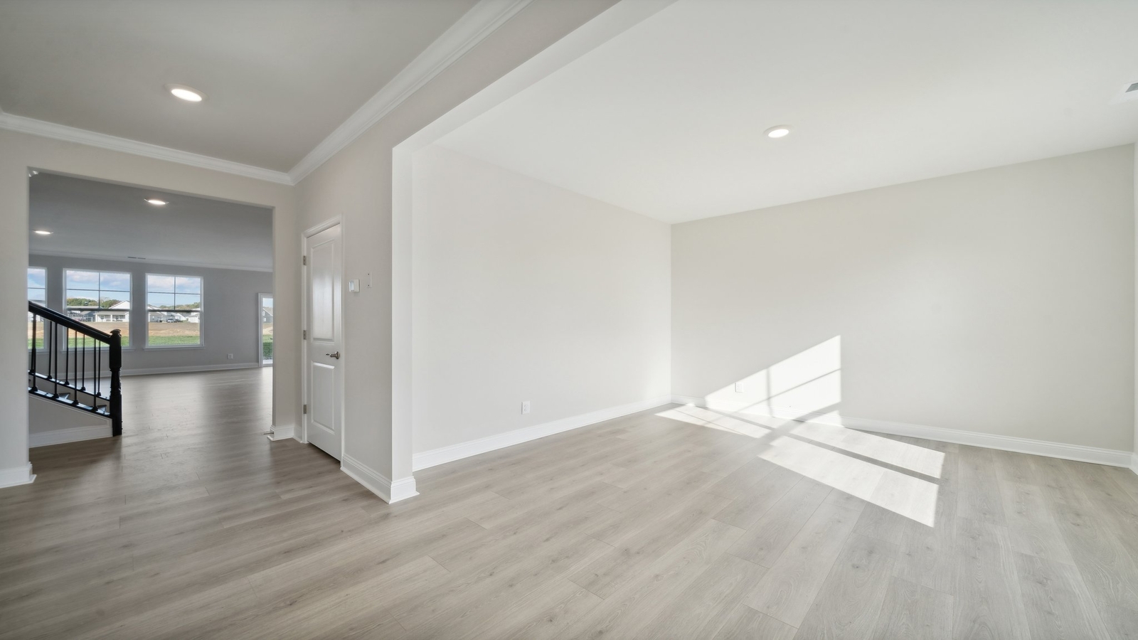 Main living space at Riverview Landing offering natural light and open layout between kitchen, dining, and living room