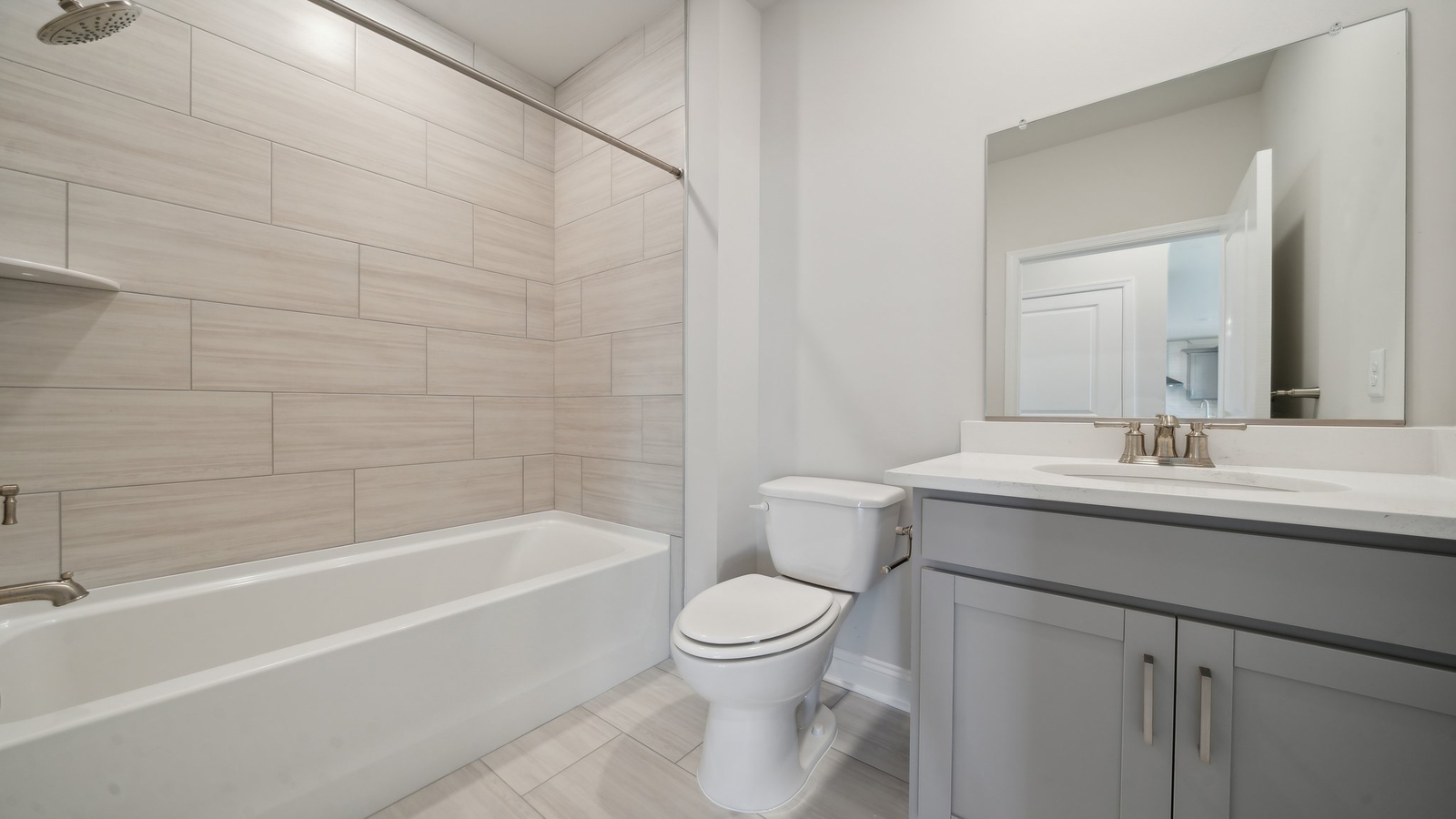 Full bathroom with tub and shower surround and transom window for light and privacy at Riverview Landing