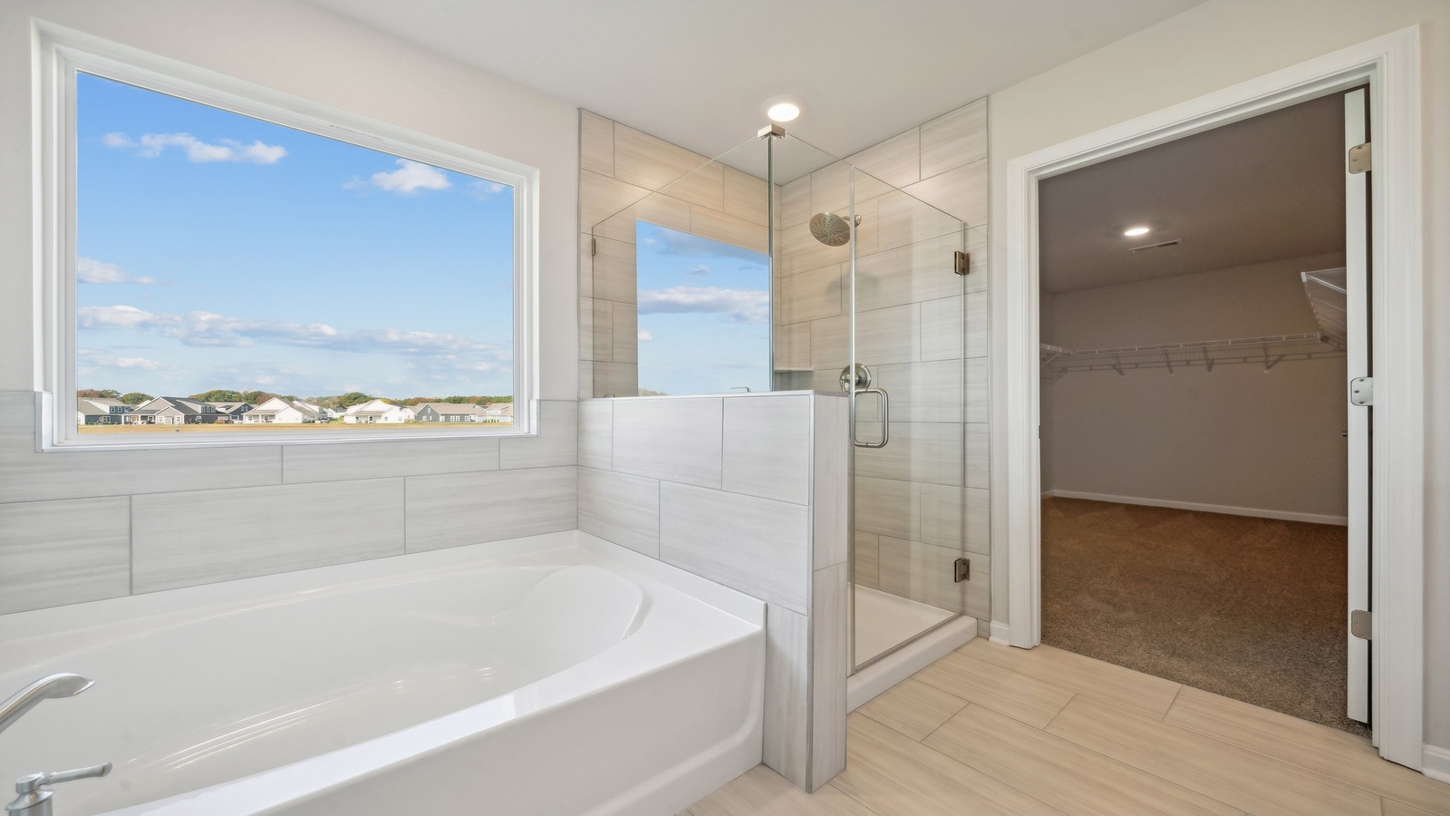 New Home showcases a D.R. Horton ensuite bathroom with quality upgrades, open layout to shower-tub, and walk-in closet