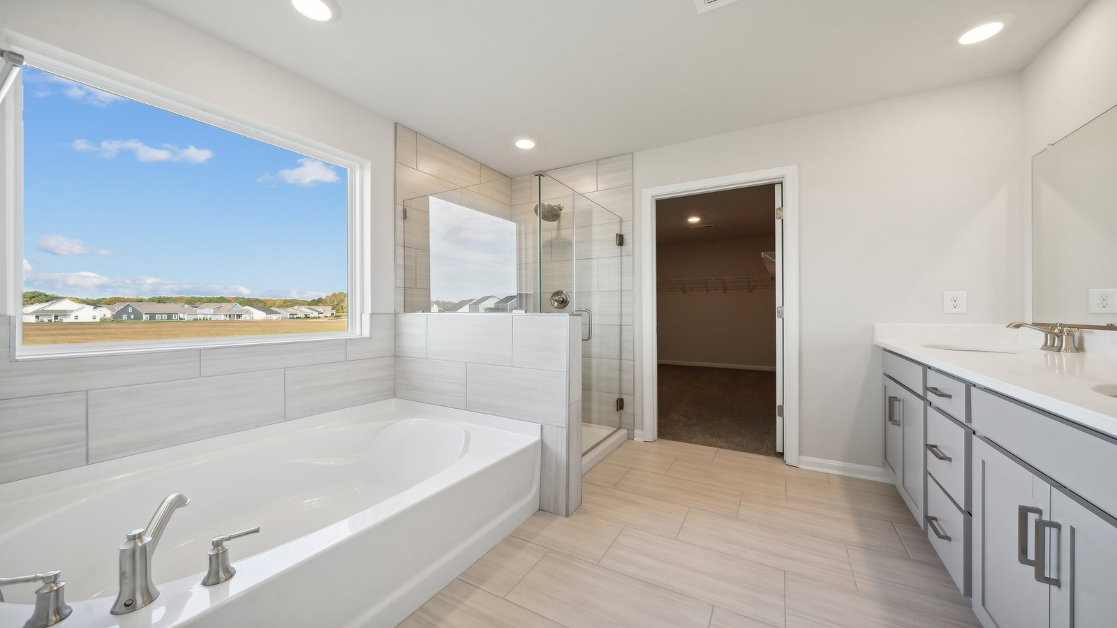Owner’s en-suite new build home offers a functional layout with a walk-in closet, and spa-like en-suite shower-bath designs