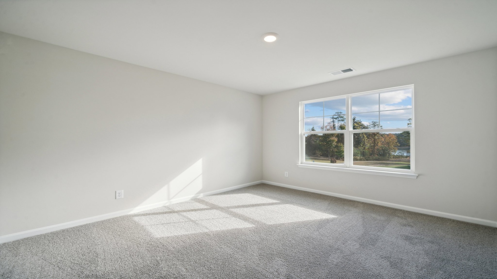 Primary bedroom in this New Home features ample space, double windows, quality carpet, a Walk-in Closet, private En-Suite Bath