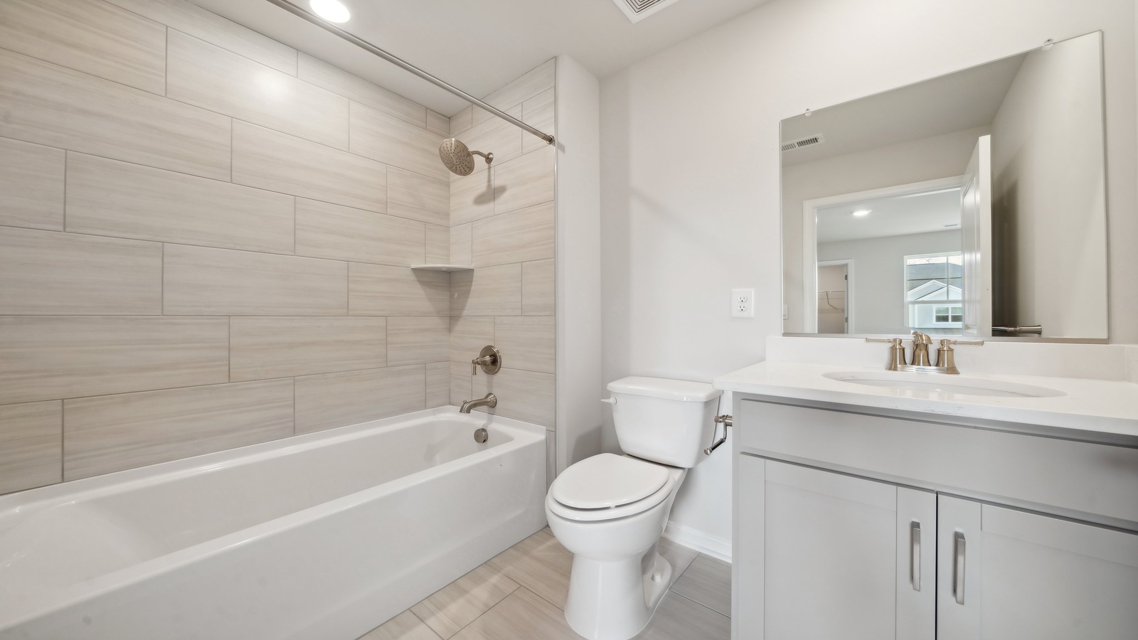 Full bathroom with tub and shower surround and transom window for light and privacy at Riverview Landing