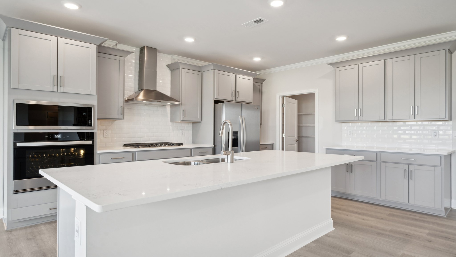 New Build Home showcasing large center island with prep zones, durable surfaces, and seating for multiple guests