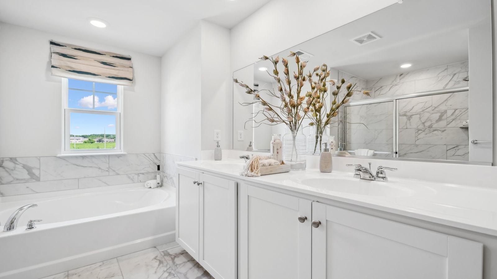 New construction home includes a thoughtful private ensuite, walk-in shower, walk-in closet, full vanity, mirror