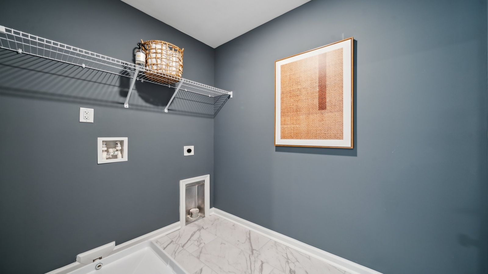 Modern laundry room in Bennetts Pasture with smart upper shelving, clean finishes, new washer, dryer