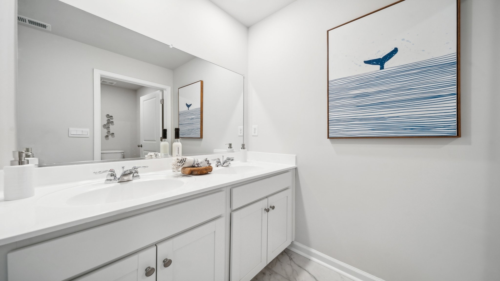 Family half bathroom with cabinet storage and bright mirror