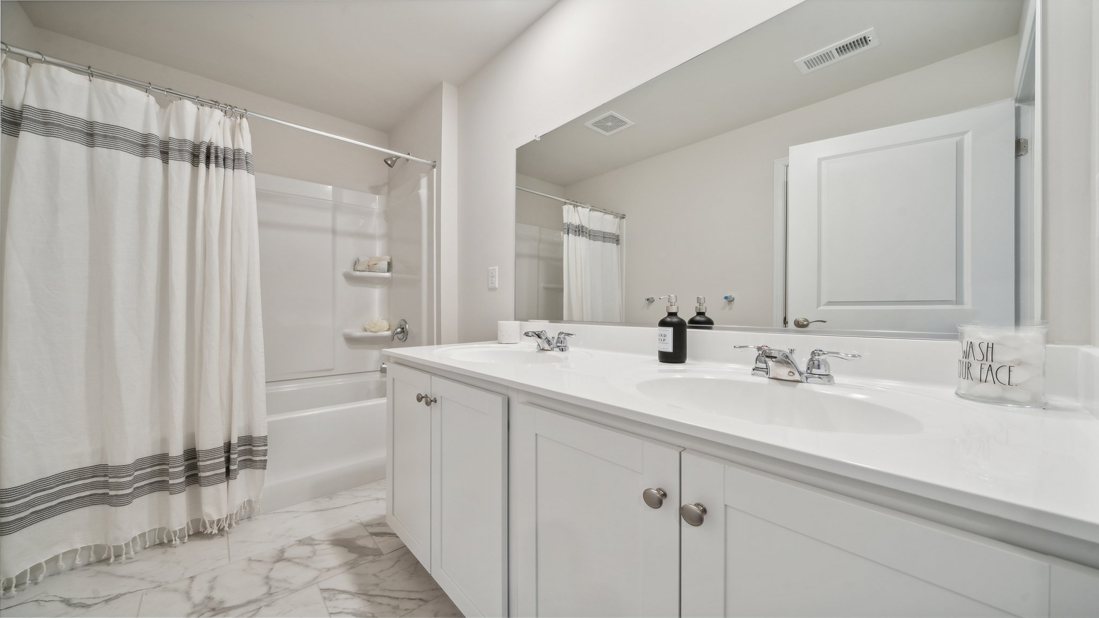 Secondary bathroom with quality combination shower-tub, cabinet storage, vanity at Bennetts Pasture