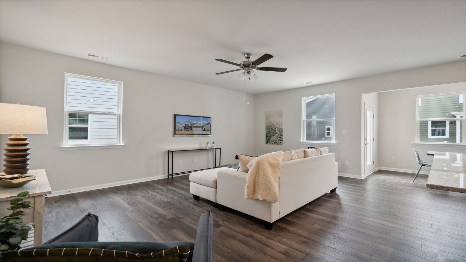 Modern living room in New Home offers backyard visibility, dining and kitchen access Bennetts Pasture