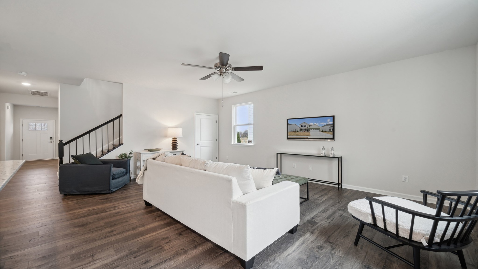 Smartly designed living room in D.R. Horton Bennetts Pasture home near main foyer, kitchen, living room, stairs