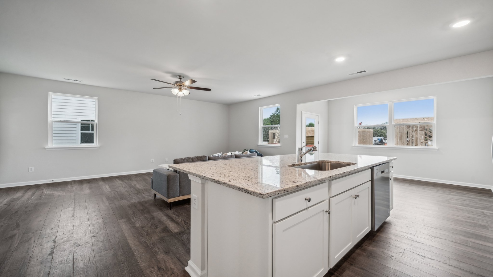 New build home showcasing large center island with prep zones, durable surfaces, and seating for multiple guests