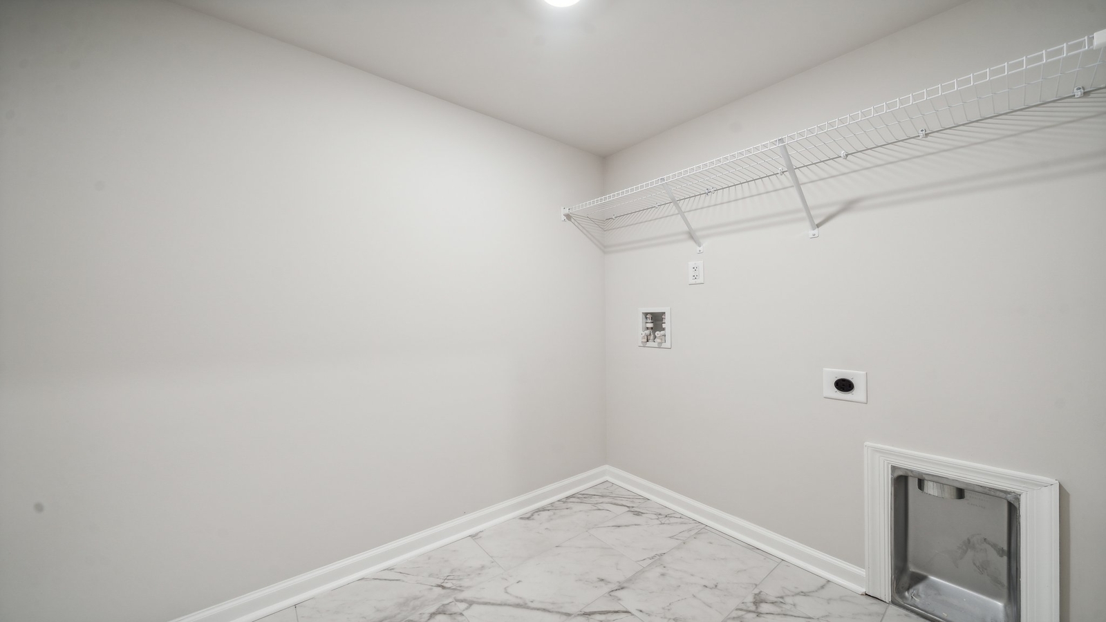 Bennetts Pasture utility laundry room’s smartly designed overhead storage for efficient organization, with new washer, dryer