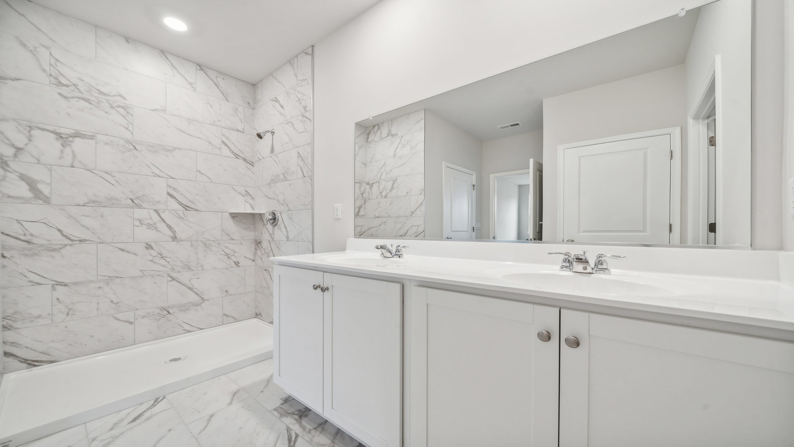 New construction homeincludes a thoughtful private ensuite, walk-in shower, walk-in closet, full vanity, mirror, backyard view