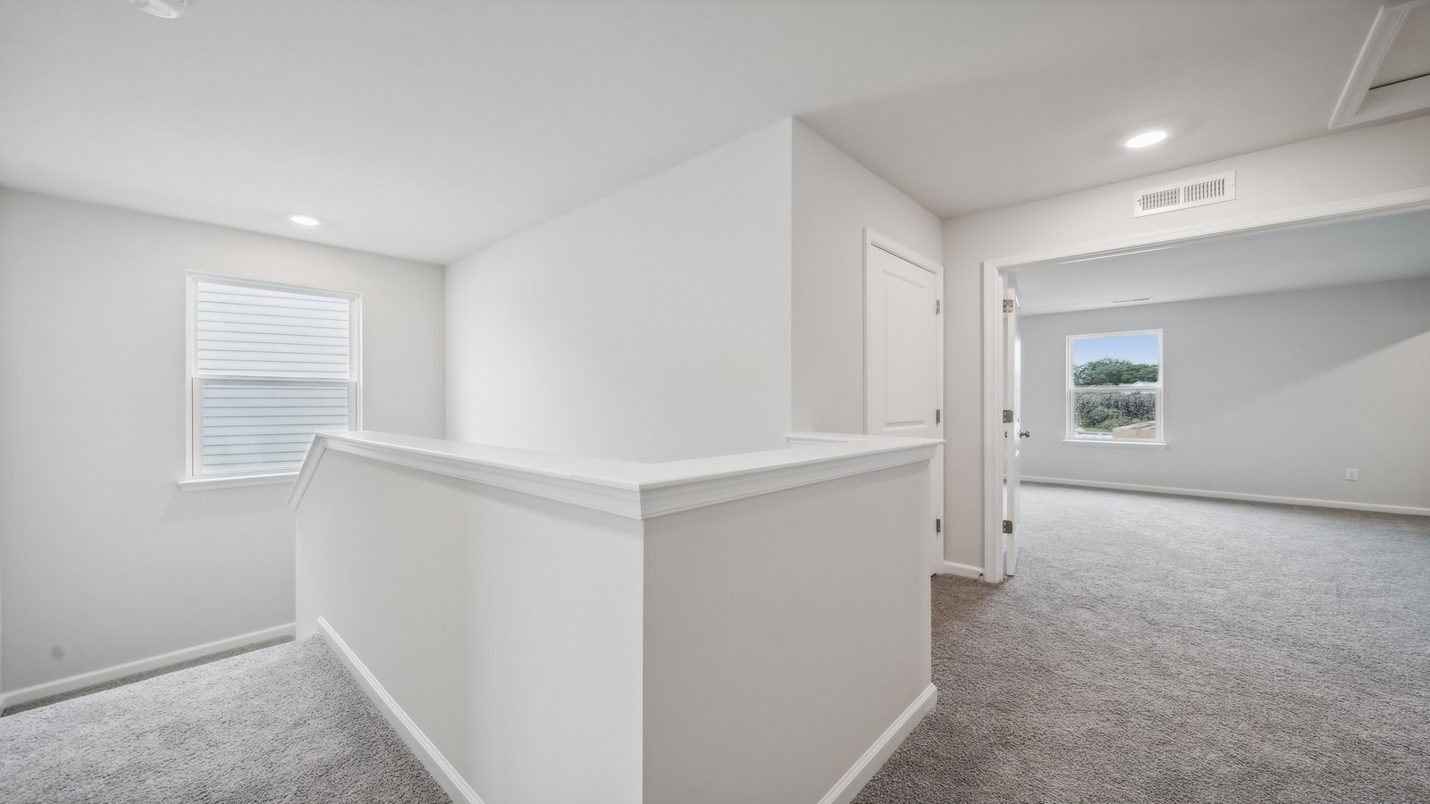 Upstairs loft with wide landing, offering multi-use and open sightlines connecting bedrooms