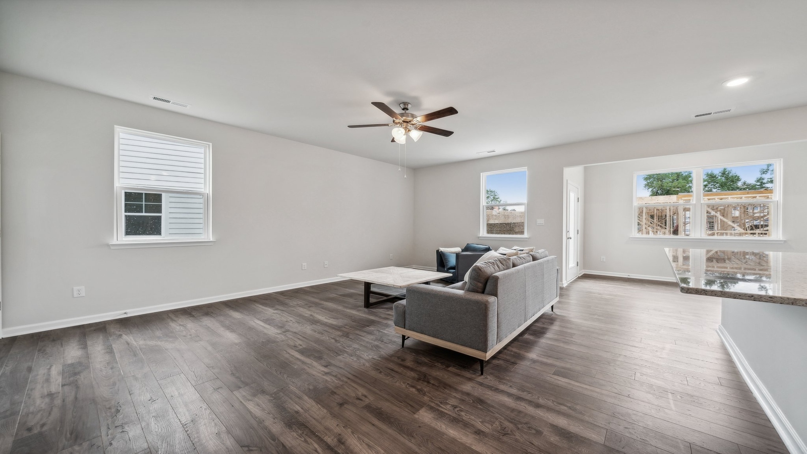 Open concept living room designs next to kitchen-dining areas with broad sightlines and clean finishes