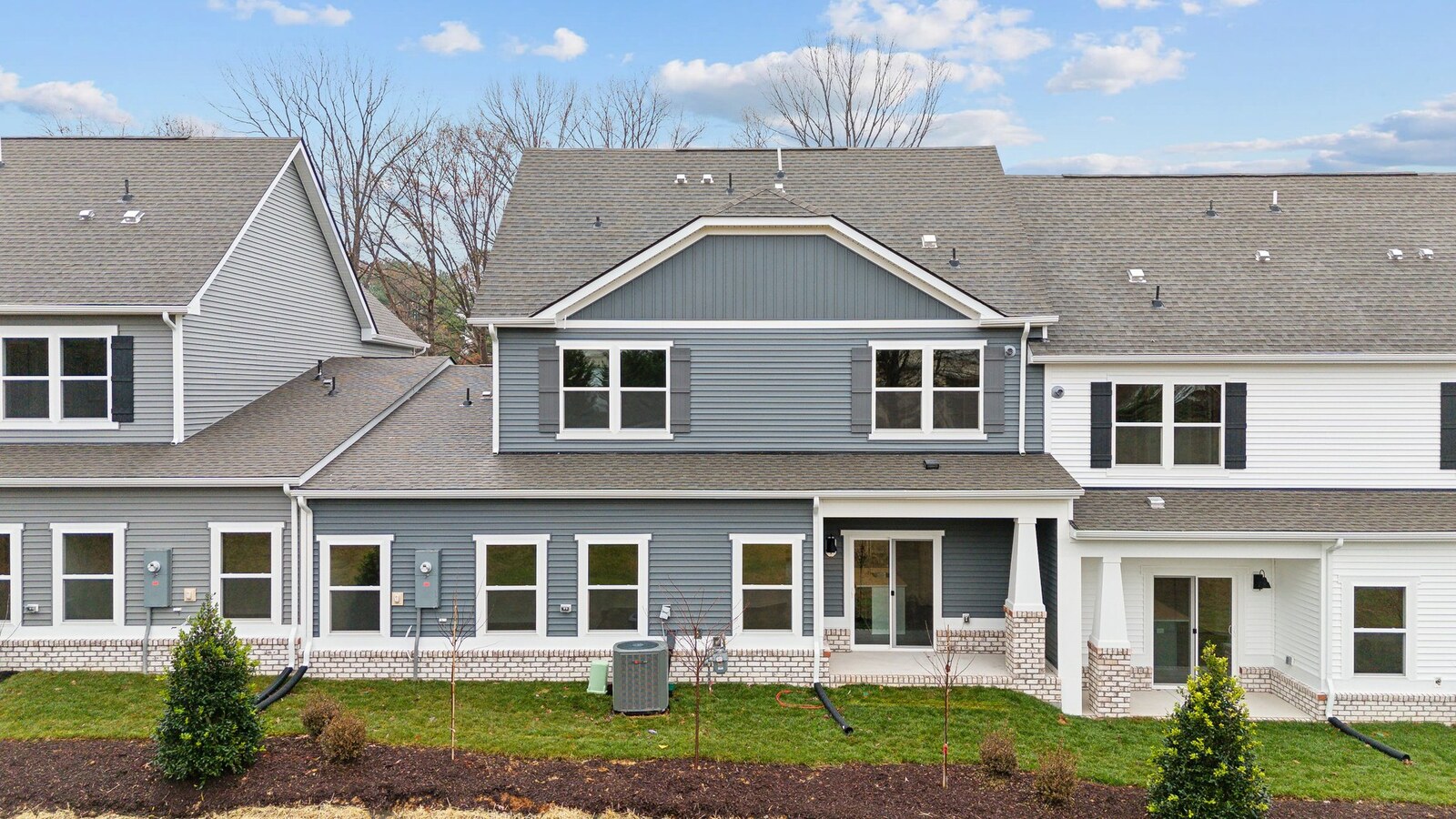 Backyard with concrete patio area offering room for seating, grill setup, adds a transition from indoor to outdoor living