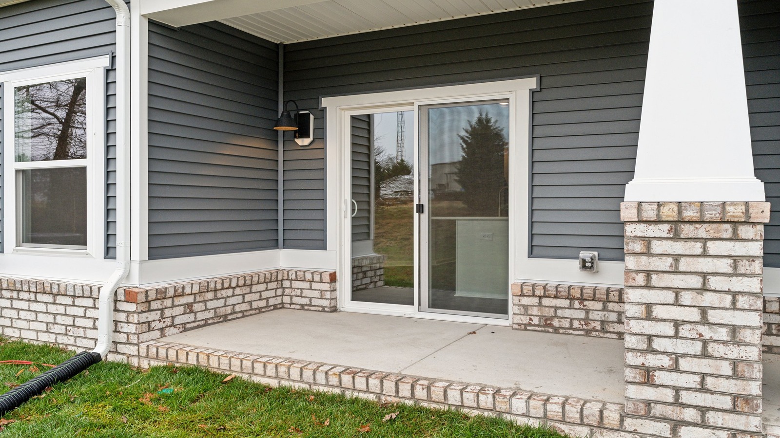 New D.R. Horton townhome featuring covered concrete patio for outdoor entertaining and a backyard space ideal for gatherings