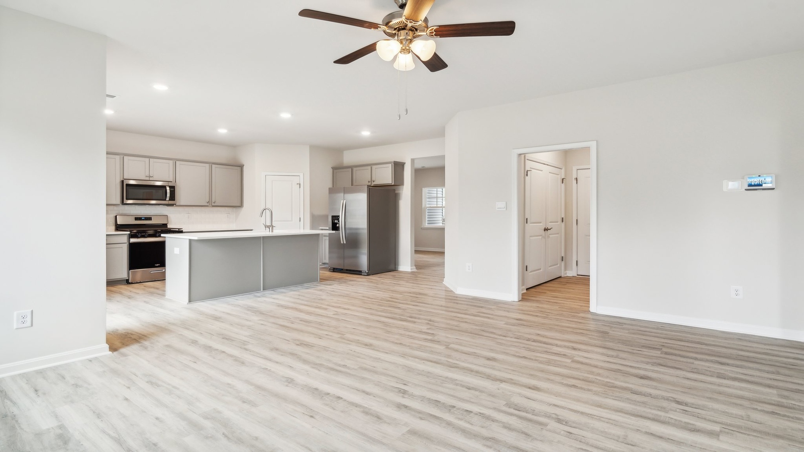 Main front door level living room offers a bright space and open concept connections to kitchen and living spaces