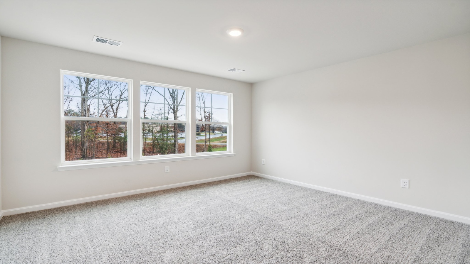 Secondary bedroom in this new home includes soft carpet, bright window light, closet, ideal for guest or child use