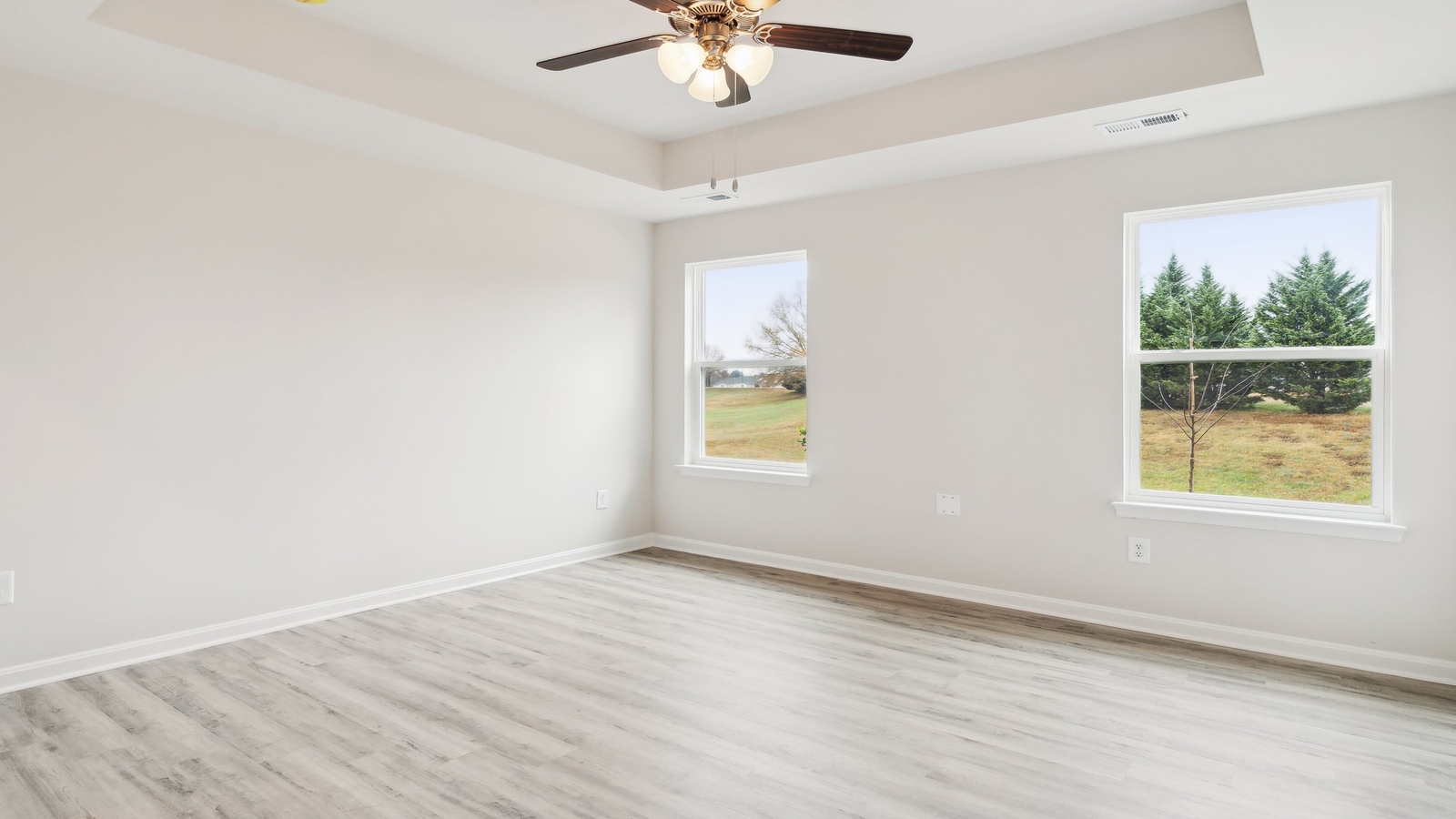 Bright and open owner's bedroom in Oak Crest Townhomes overlooking the backyard, ensuite bathroom, walk-in closet