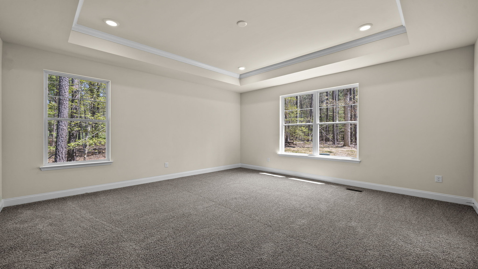 Spacious primary bedroom in our New Construction Home includes Premium Design finishes and quiet rear-facing windows.