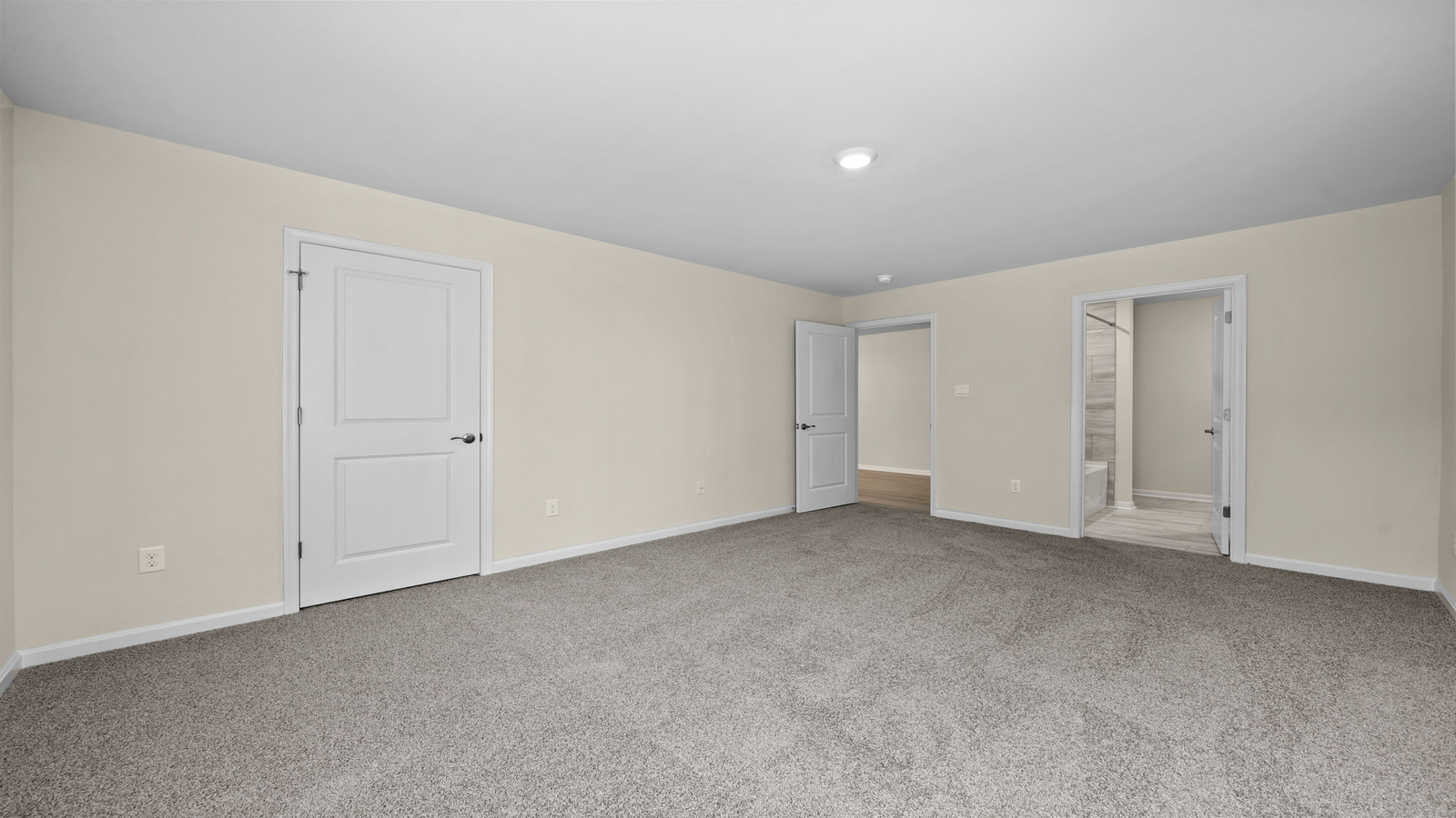 Cozy secondary bedroom with privacy door, closet, and hallway connection to shared bath