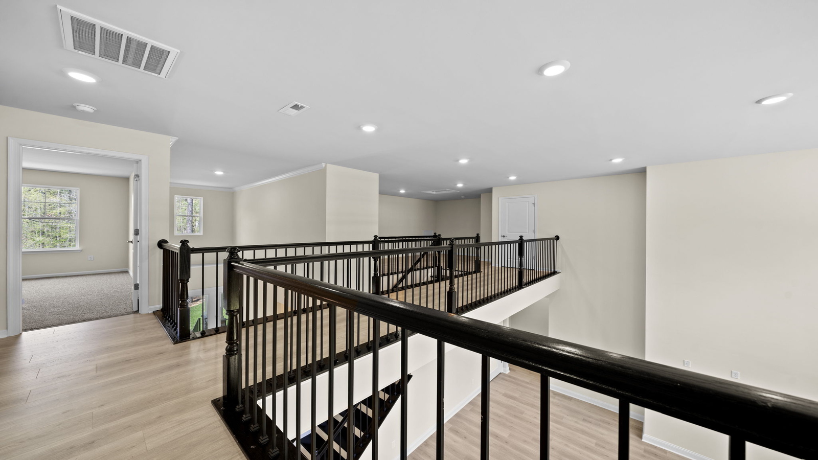 Bright loft area designed for multi-use with nearby bathroom and secondary bedroom access