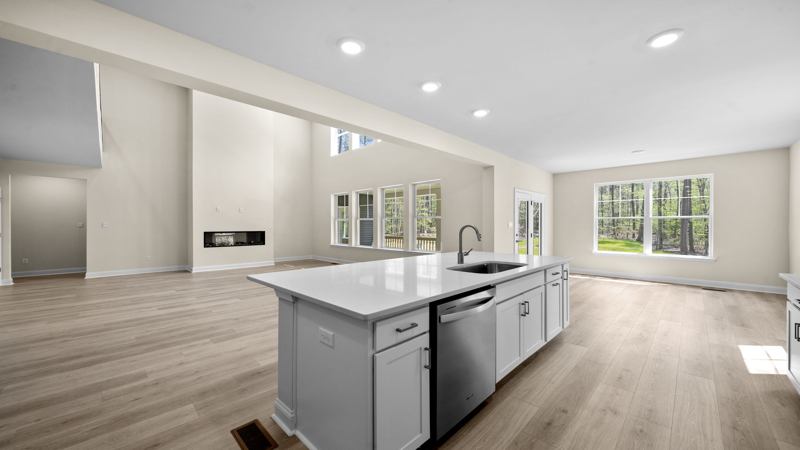 Kitchen island in D.R. Horton layout connects dining and living areas with efficient flow and modern surface finishes