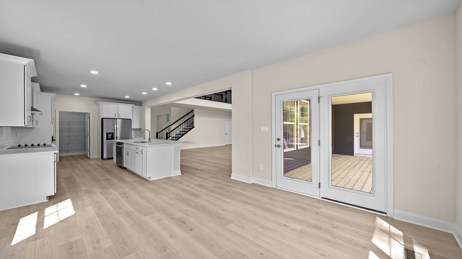 New Build Home kitchen showcasing a large center island, pantry, new appliance suite, multiple seating options