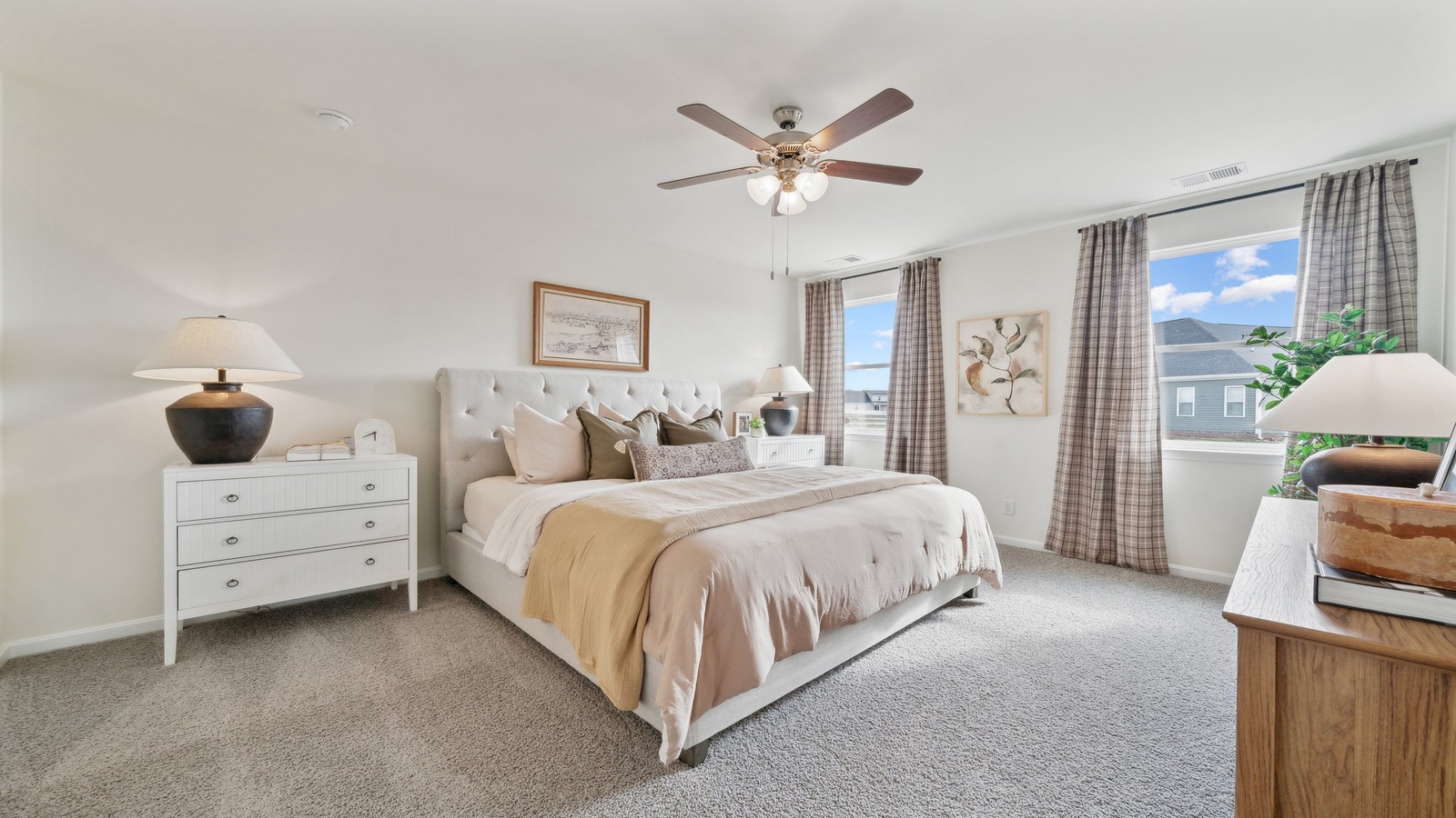 Bright and open primary bedroom in Tooley Harbor with walk-in closet, stylish spa-inspired ensuite, overlooking backyard