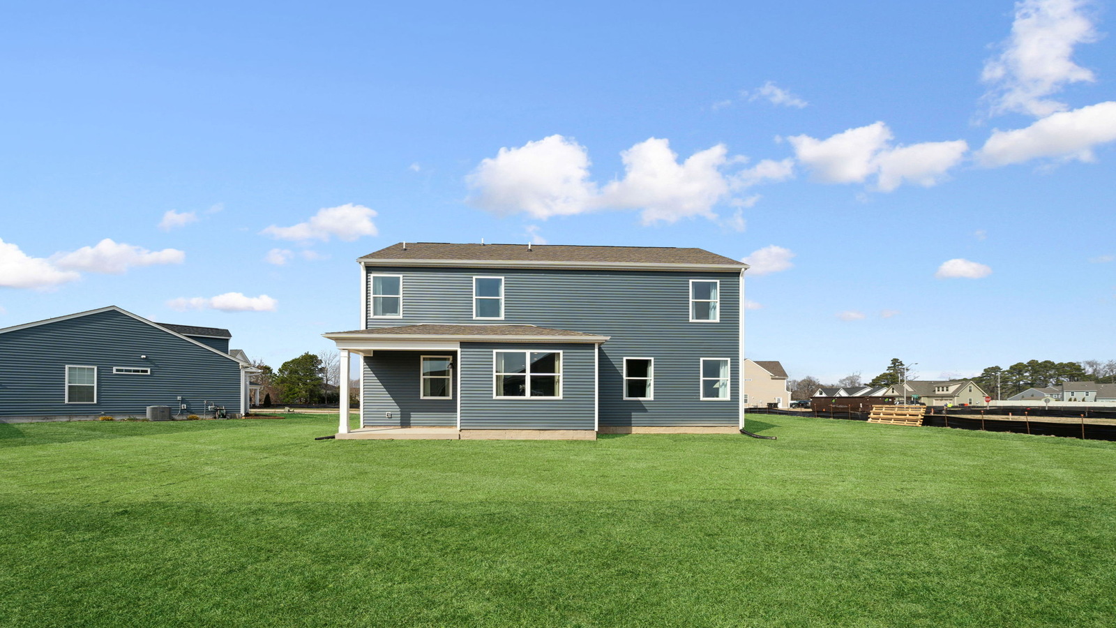 New House by D.R. Horton featuring paved patio for outdoor entertaining. Backyard with grass, ideal for gatherings