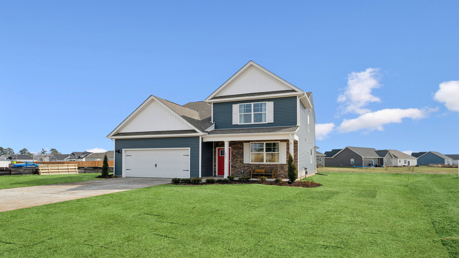 New build home at 302 Genoa Drive, Elizabeth City, NC, Tooley Harbor two-story, porch, garage, grass