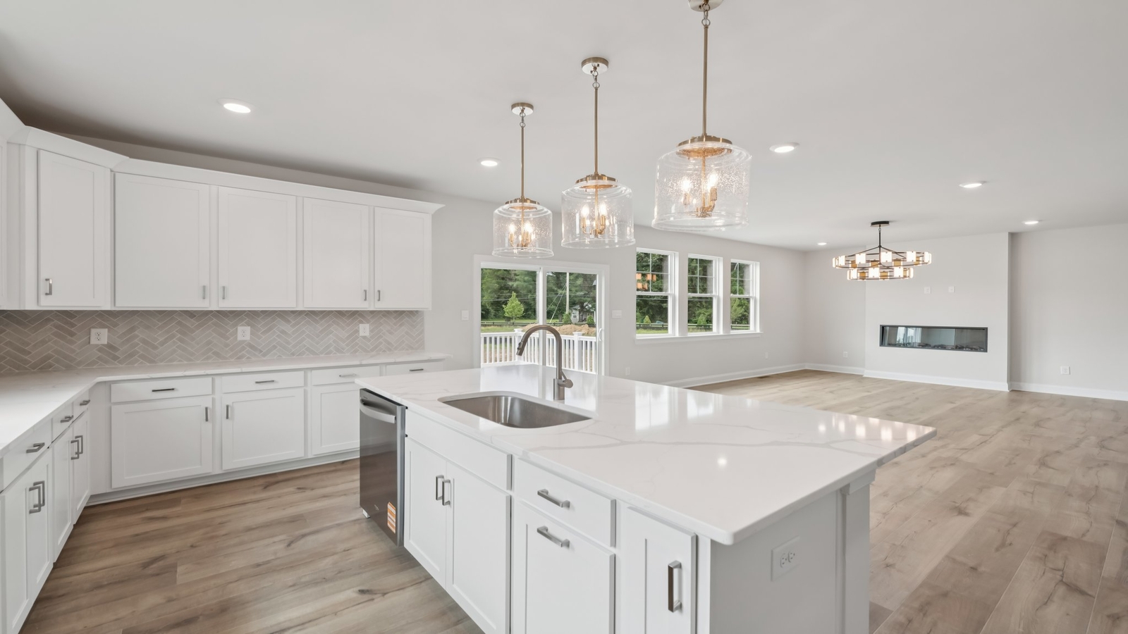 Kitchen-dining and family room blend with quality flooring, backyard views, and access in the New Home