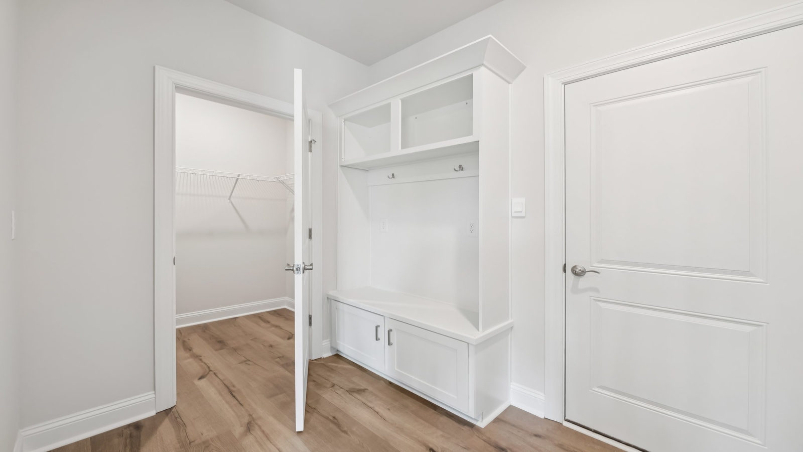 Functional mudroom design with garage-kitchen acess in D.R. Horton New Build Home located in a planned community