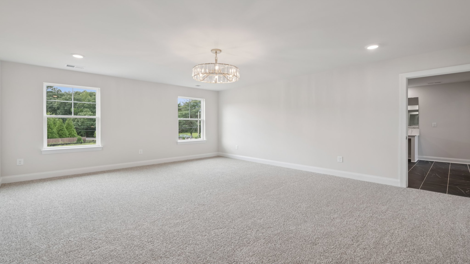 Primary bedroom in this New Home features ample space, double windows, quality carpet, a Walk-in Closet, private En-Suite Bath